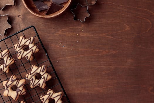 Freshly baked homemade star-shaped cookie with chocolate on the grid on the wooden table with a copy space, horizontal banner