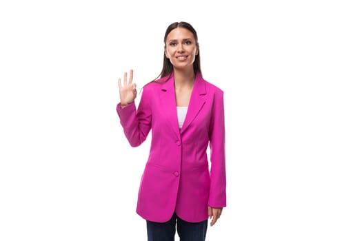 young confident successful brunette successful boss woman dressed in a stylish pink jacket.