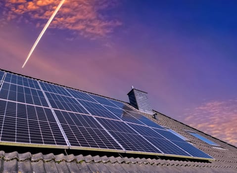 Solar panels producing clean energy on a roof of a residential house