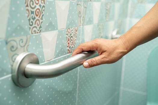 Asian elderly woman use bathroom handle security in toilet, healthy strong medical concept.