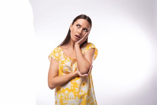 young attractive brunette woman thinking on a white background.