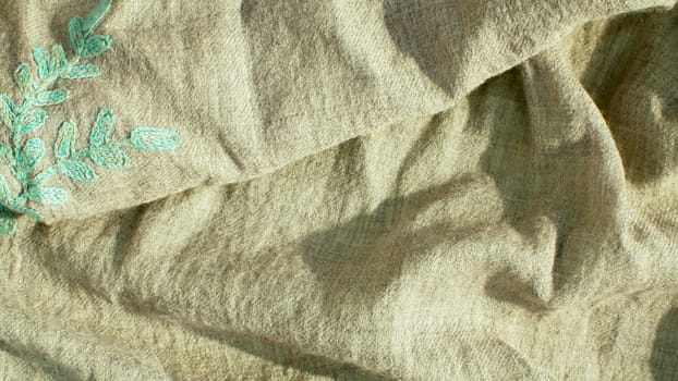 Extreme close up - gray natural fabric with embroidery. Texture, textile background