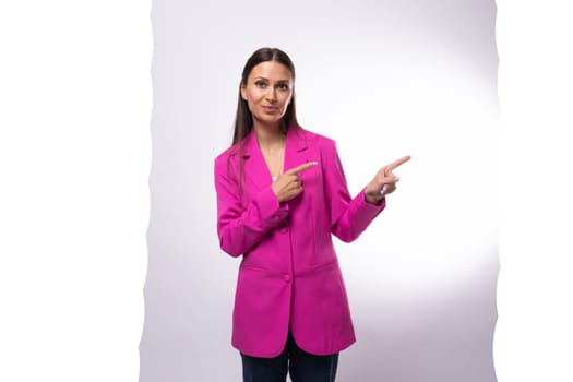a young caucasian brunette business lady dressed in a bright crimson jacket points her hand to the side.
