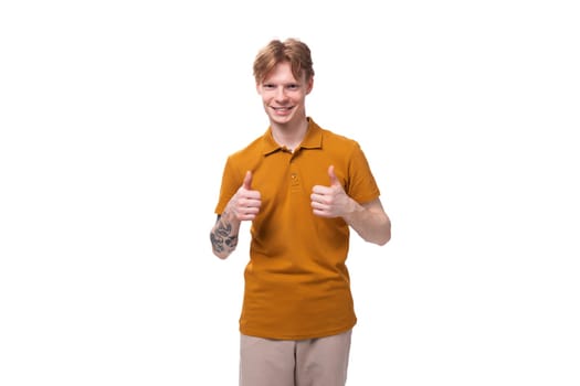 portrait of a young guy with short red hair dressed in a summer T-shirt on a white background.