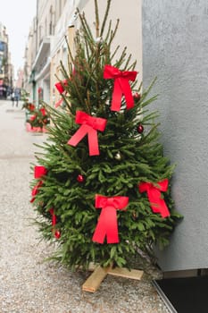 Christmas tree in the city decorated with red bows