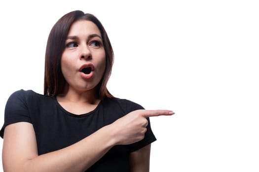 Young surprised woman looking to the side against a background with copy space.