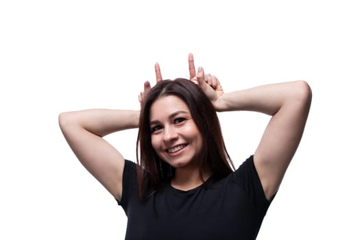 Young carefree woman with brown eyes wearing a black T-shirt, close-up portrait.