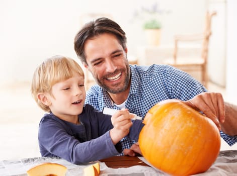 Wait, one last thing. A father and son marking a pumpkin at home for halloween