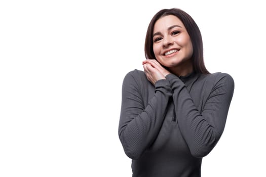 Happy young stylish woman with black hair smiling on white background.