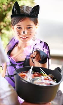 She loves dressing up. Little children trick-or-treating on halloween