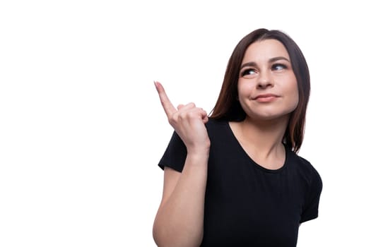 A woman dressed in a black T-shirt points her finger at the advertising space.