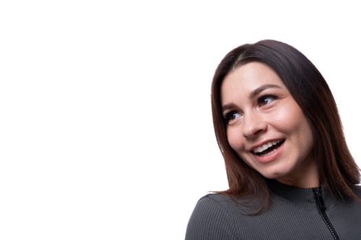 25 year old woman with black hair smiling sweetly, close-up photo on a white background with copy space.