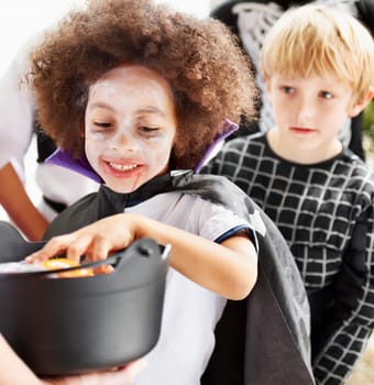 They love halloween. Little children trick-or-treating on halloween