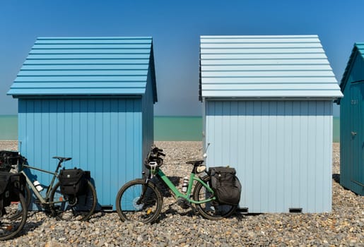 Blue wooden cabins and bikes on the ocean Dieppe