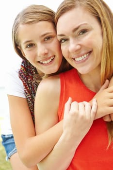 My mother is my best friend. Smiling mother and daughter embracing while outdoors