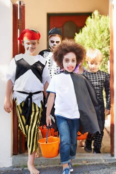 What little monsters. Little children trick-or-treating on halloween