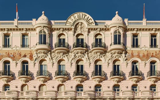 Monaco, Monte Carlo, 27 September 2022: The facade of famous Hotel Hermitage at sunny day, building of yellow color, balcony, bas-relief. High quality photo