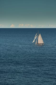 Monaco, lonely vintage sail yacht in sea at sunset, huge sail boat, wealth life of billionaires . High quality photo