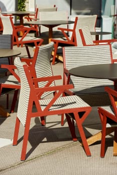 Empty stylish red chairs in one of the restaurants in Monaco on a sunny day. High quality photo