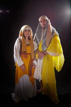 A couple in love or a married couple in stylized Eastern clothing from Israel, Palestine, Iran, Pakistan together. Tender photo session in the style of the Middle East and the Bible