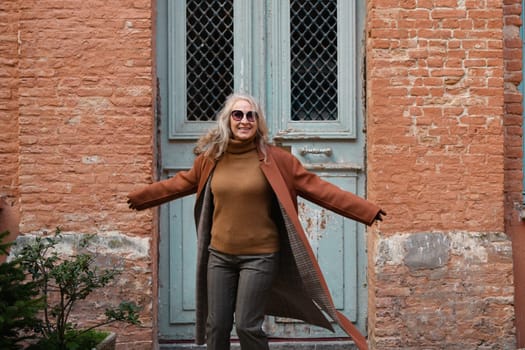 Woman in terracotta coat and leather gloves