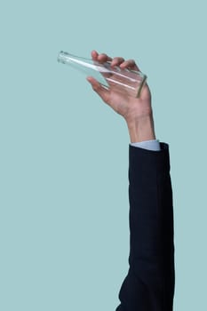 Businessman's hand holding glass bottle on isolated background. Eco-business recycle waste policy in corporate responsibility. Reuse, reduce and recycle for sustainability environment. Quaint