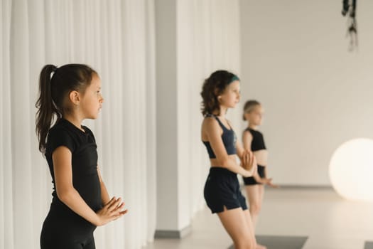 Children do Yoga in the fitness room. Children's gymnastics.