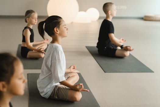 Children do Yoga in the fitness room. Children's gymnastics.