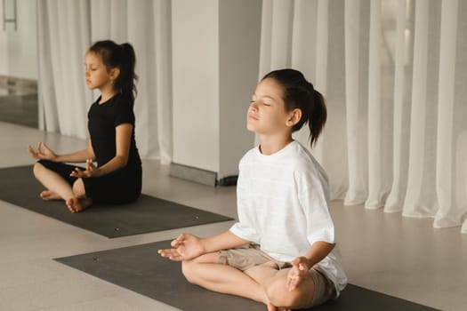 Children do Yoga in the fitness room. Children's gymnastics..