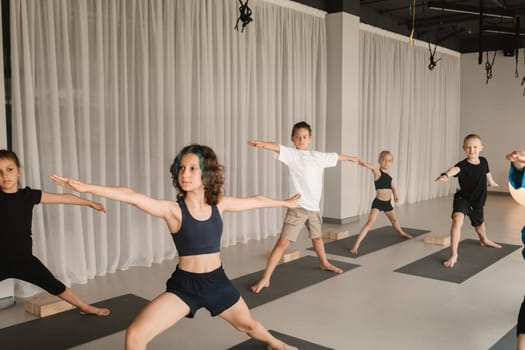 Children do Yoga in the fitness room. Children's gymnastics.