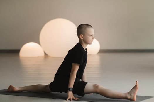 A child practices yoga poses indoors. Children's yoga.