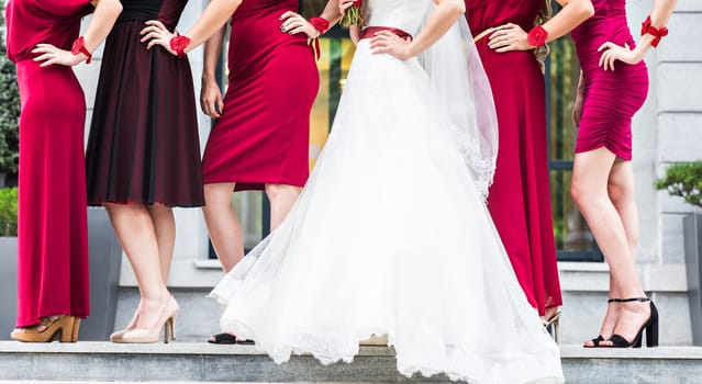 Bride with bridesmaids on the park on the wedding day