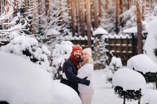 A cheerful couple, a man and a woman on the street in the snowy season.