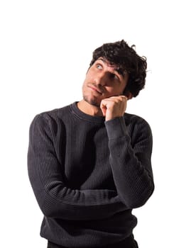 A man in a black sweater is posing for a picture, looking up day-dreaming or thinking, pondering about something, isolated on white
