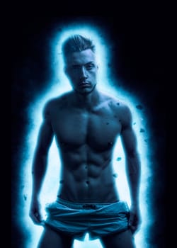 A man with no shirt standing in front of a blue light