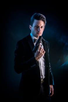 A man in a tuxedo holding a gun