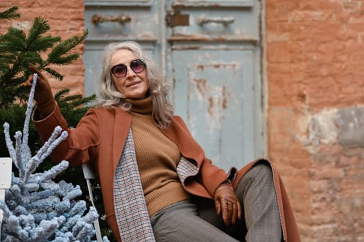 A stylish woman in terracotta coat and leather gloves