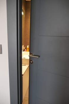 gray bathroom door slightly open
