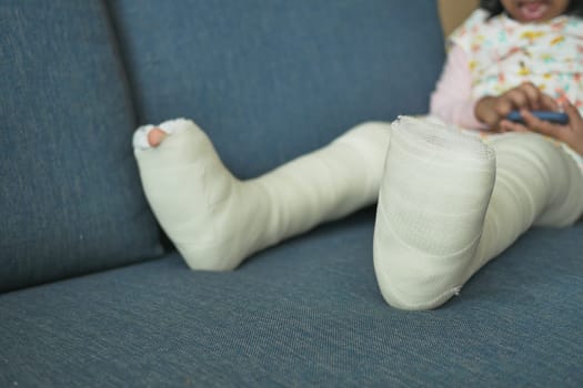 little child boy with plaster bandage on leg