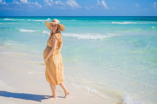 Radiant and expecting, a pregnant woman stands on a pristine snow-white tropical beach, celebrating the miracle of life against a backdrop of natural beauty.