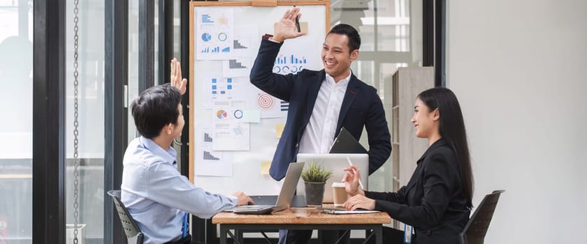 colleagues asking a question to a businessman during a presentation..