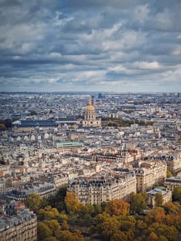 Aerial view of Paris cityscape, France. Les Invalides building with golden dome. Autumn parisian scene, vertical background