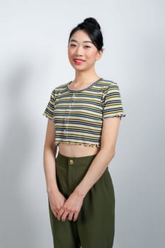 attractive asian woman feeling happy in front of a white background