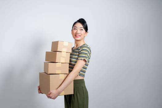 Happy cute asian woman smiling and holding package online marketing and delivery 