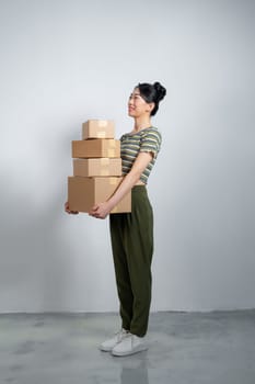 Portrait of beautiful happy woman carry boxes with orders.