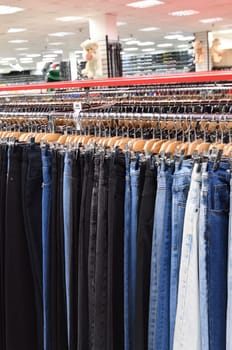 Jeans hanging in row in a store