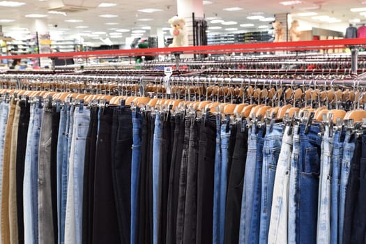 Jeans hanging in row in a store