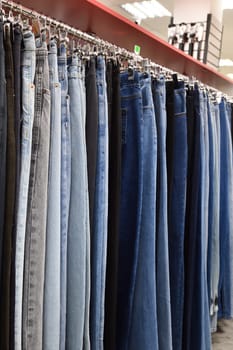 Jeans hanging in row in a store