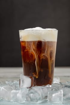 Iced coffee latte in glass cup on wooden table