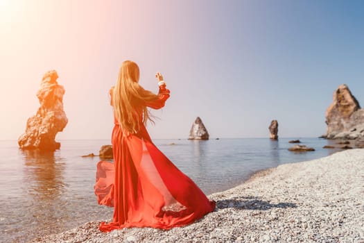 Woman travel sea. Happy tourist taking picture outdoors for memories. Woman traveler looks at the edge of the cliff on the sea bay of mountains, sharing travel adventure journey.